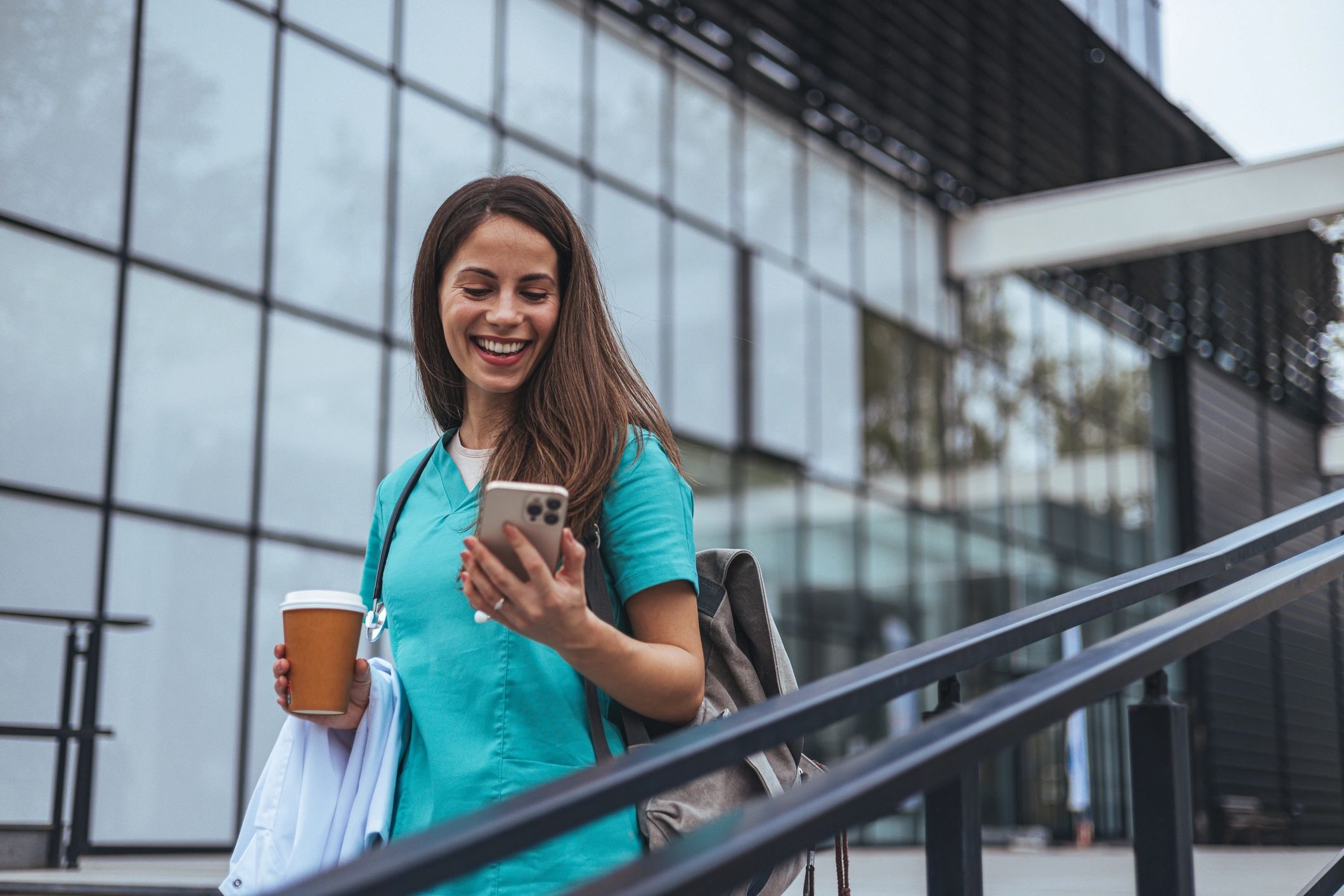 Healthcare professional using a smartphone outdoors